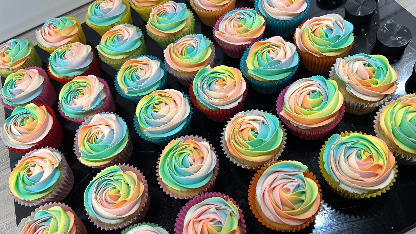 A large collection of colourful cupcakes made by Kimmy